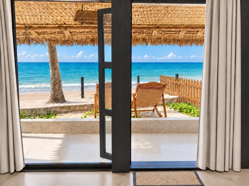 Sea view through open doors and ivory curtains inside a Premium Couple Villa at Dwipantor Beach Resort, Saint Martin’s Island